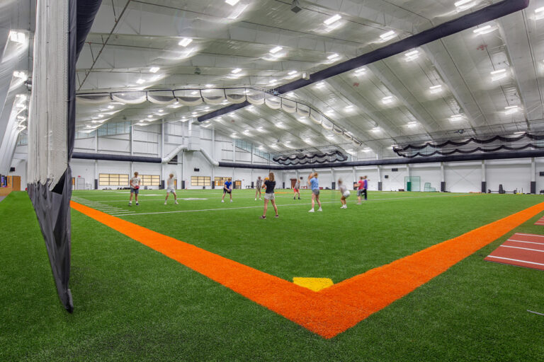 Students practice on the school's indoor athletic field