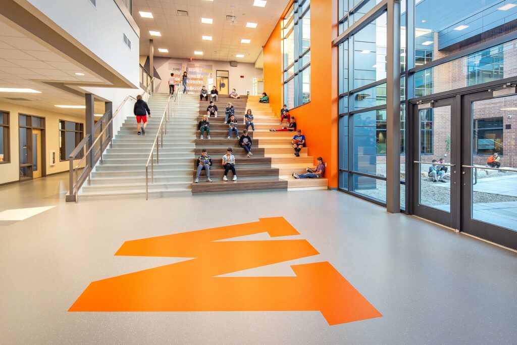 Students read at the school's learning stair, which is adjacent to an outdoor courtyard.