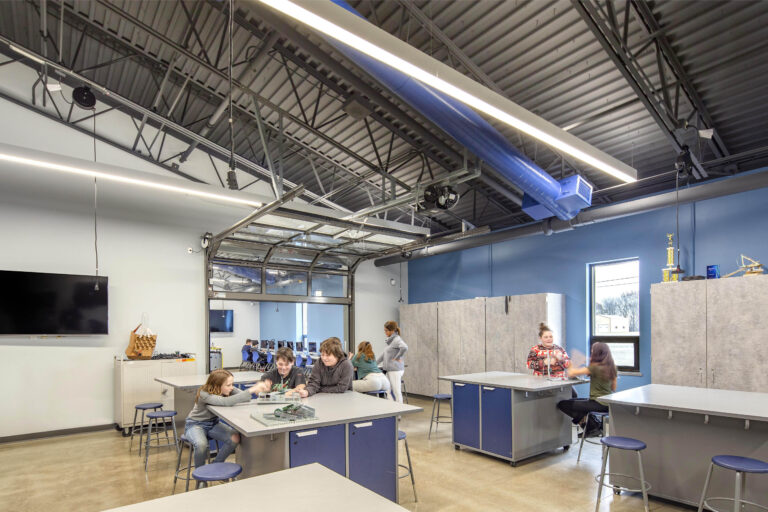 A vaulted, industrial ceiling tops off lab tables, where students collaborate on STEM projects at Wheatland Center School
