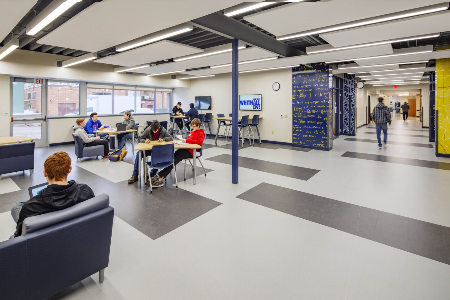 Students work at flexible furniture in a STEM commons off a hallway in Whitnall High School