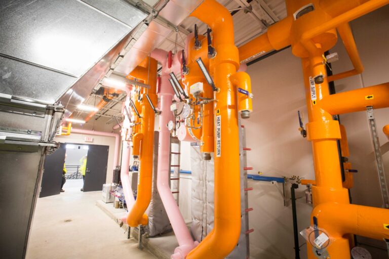 Close look at orange pipes in the maintenance facility building