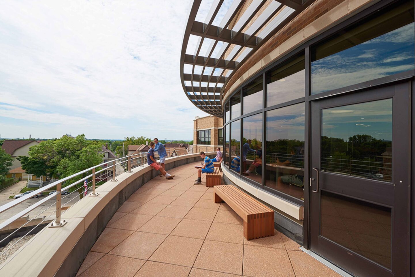 A view of the curved patio with a brise soleil and bench seating