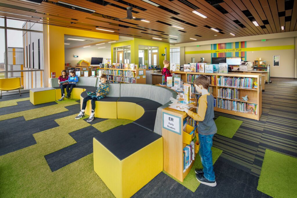 Discovery center and library space with curved furniture and brand colors