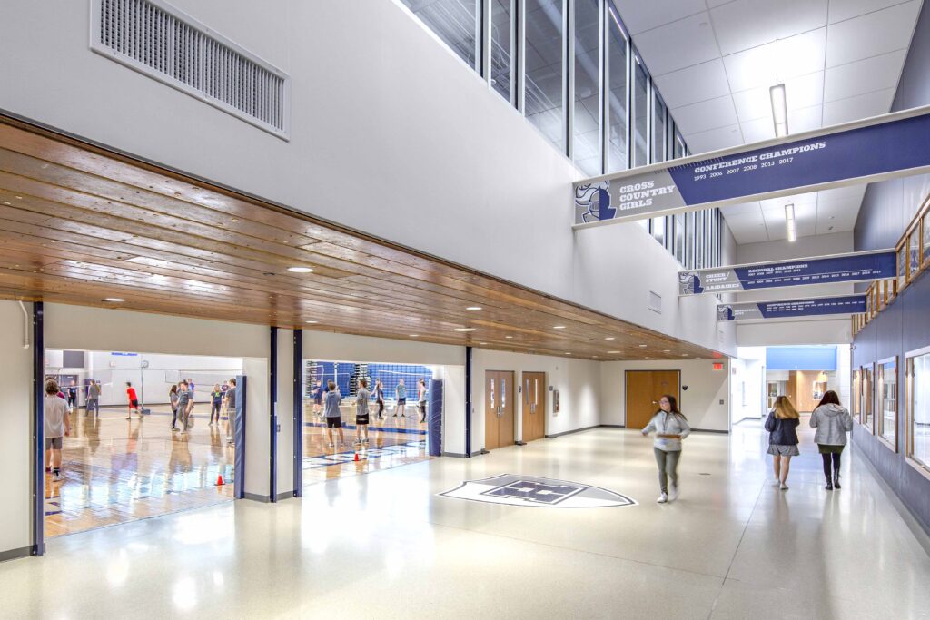 A view of the gymnasium lobby with a view into the gymnasium via the open overhead doors