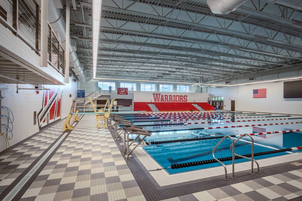 A view of the starting block-end of the pool, including the pool office and mezzanine in the background