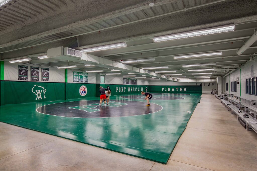 Student-athletes practice in the three-ring wrestling room.