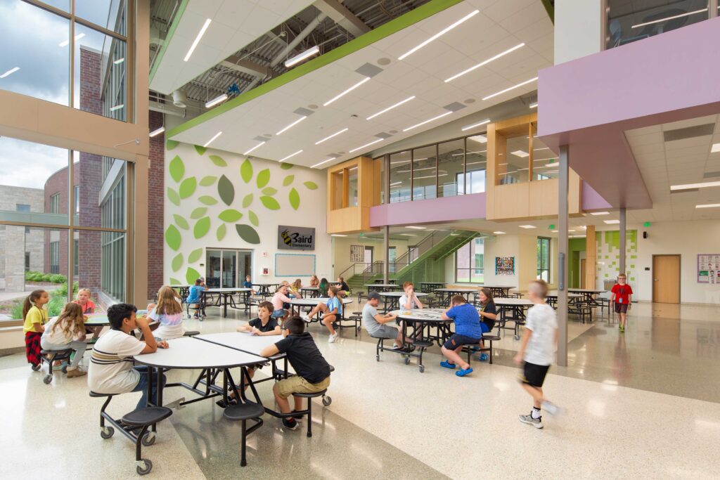 Baird Elementary School cafeteria with visible exterior windows to playground and second floor windows