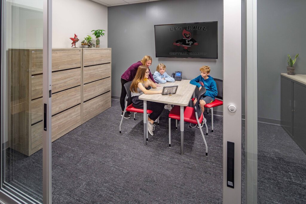 Both staff and students can use this conference room at Les Paul Middle School. The sliding glass partitions balance privacy and supervision.