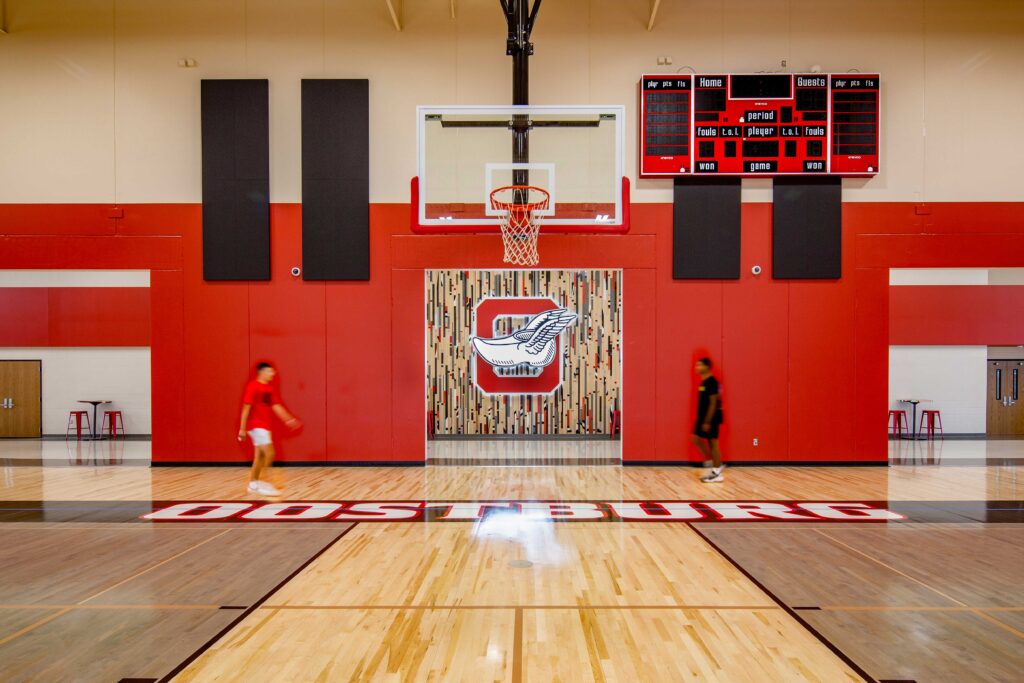 Oostburg High School Gym featuring the old gym floor background with illuminated logo