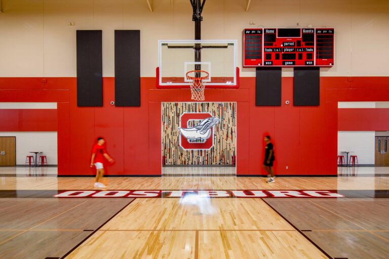 Oostburg High School Gym featuring the old gym floor background with illuminated logo
