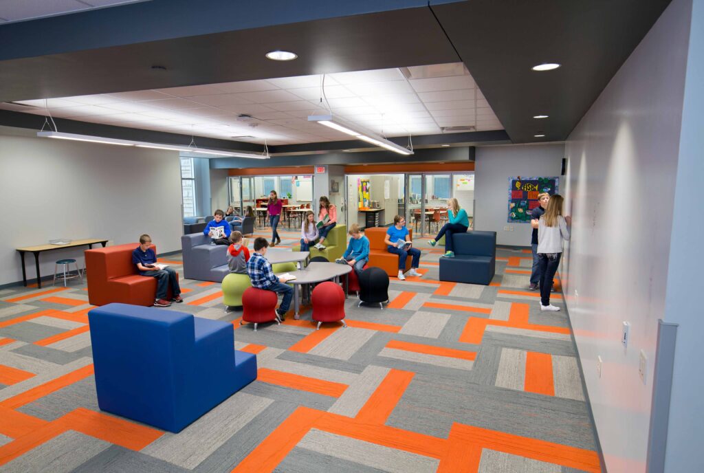 The school's collaboration spaces feature flexible furniture, whiteboards, and direct access to classrooms.
