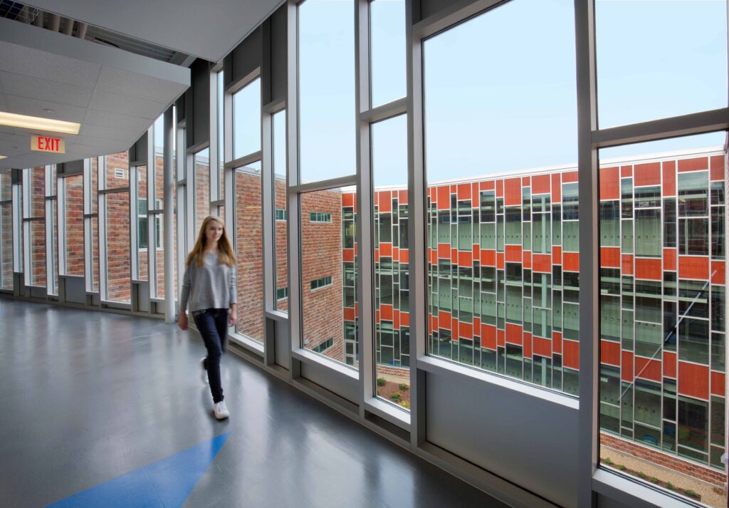 Windows span the entire height of the school's three-story addition.