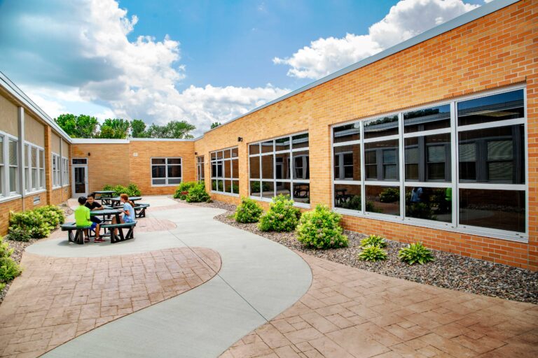 Danz Elementary School courtyard with students sitting at a table