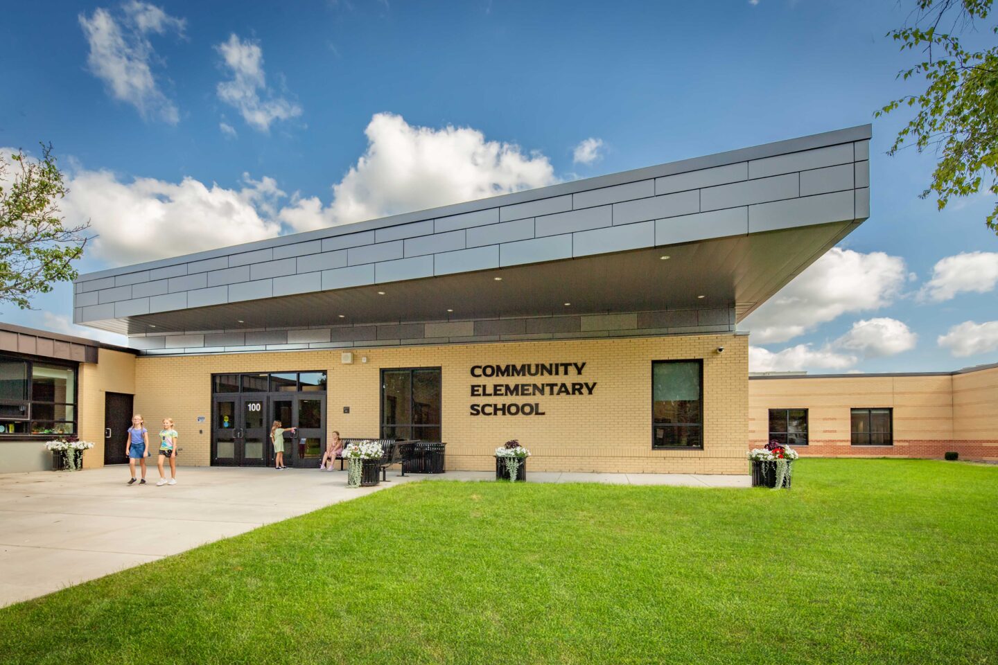 Community Elementary School Main Entrance with students walking