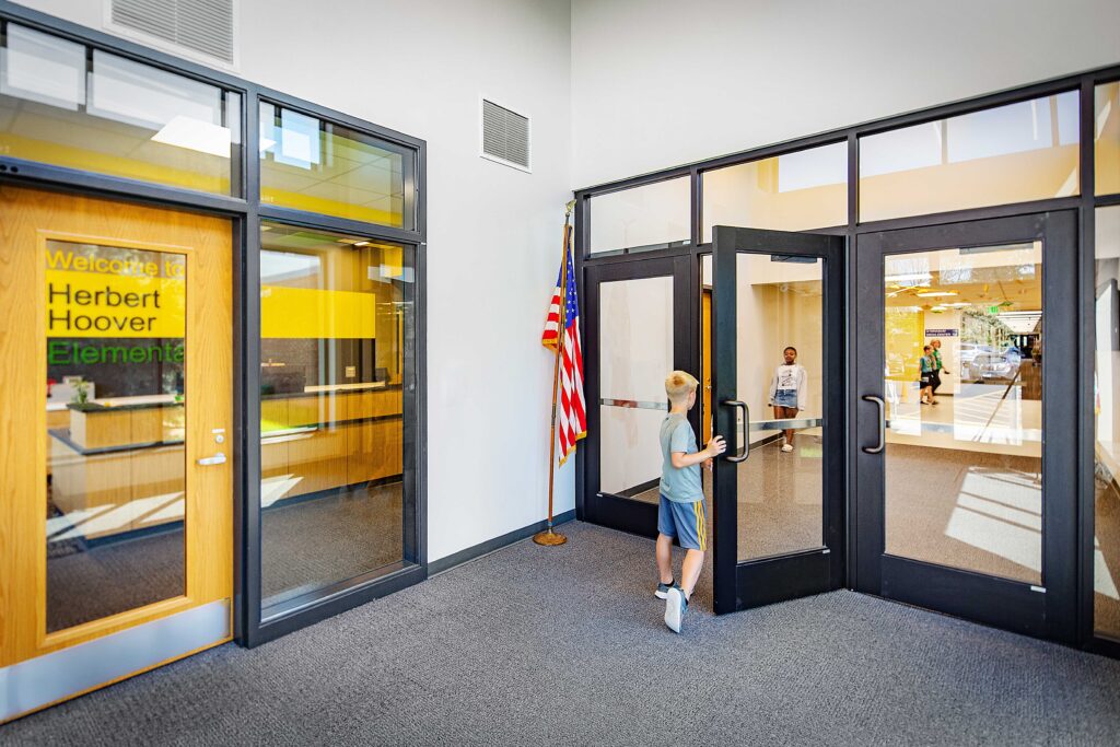 Herbert Hoover Elementary Secure Entry with student opening the door