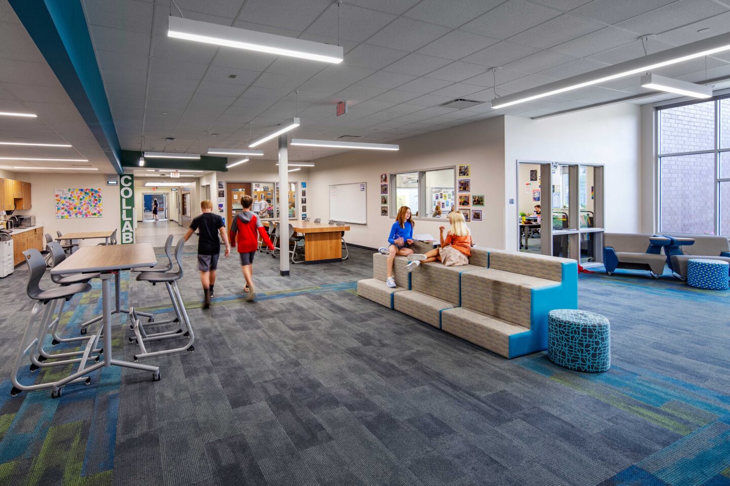 JC McKenna Middle School Resource Area looking southeast with students walking and some sitting on the chairs