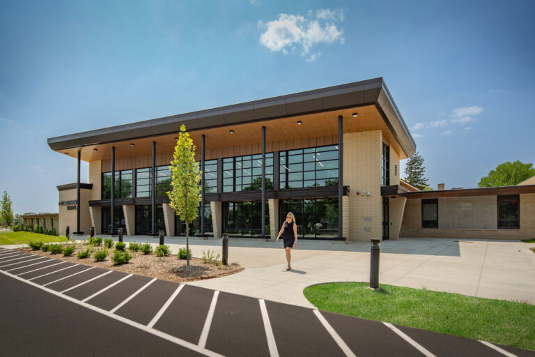 Exterior of the cafeteria, featuring an outdoor plaza and floor-to-ceiling windows