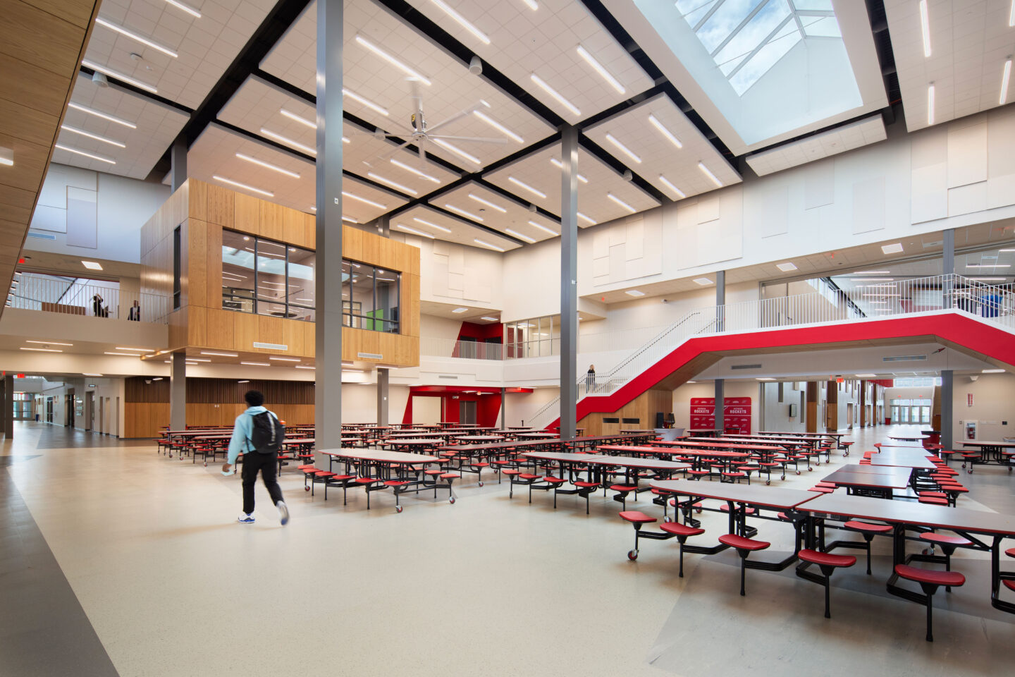 Commons/cafeteria with a staircase and views into the second floor conference rooms at Neenah High School