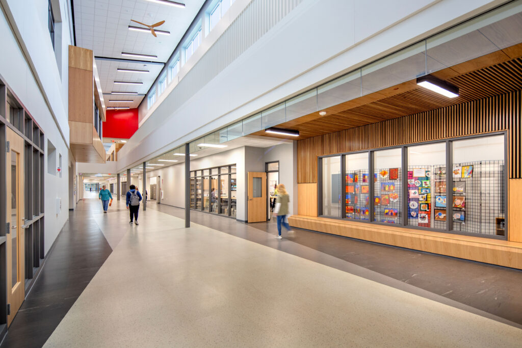 East atrium at Neenah High School featuring an art gallery wall to the right