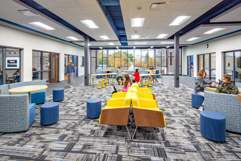 Collaboration area by classrooms at Vel Phillips Middle School with students working in the various furniture options