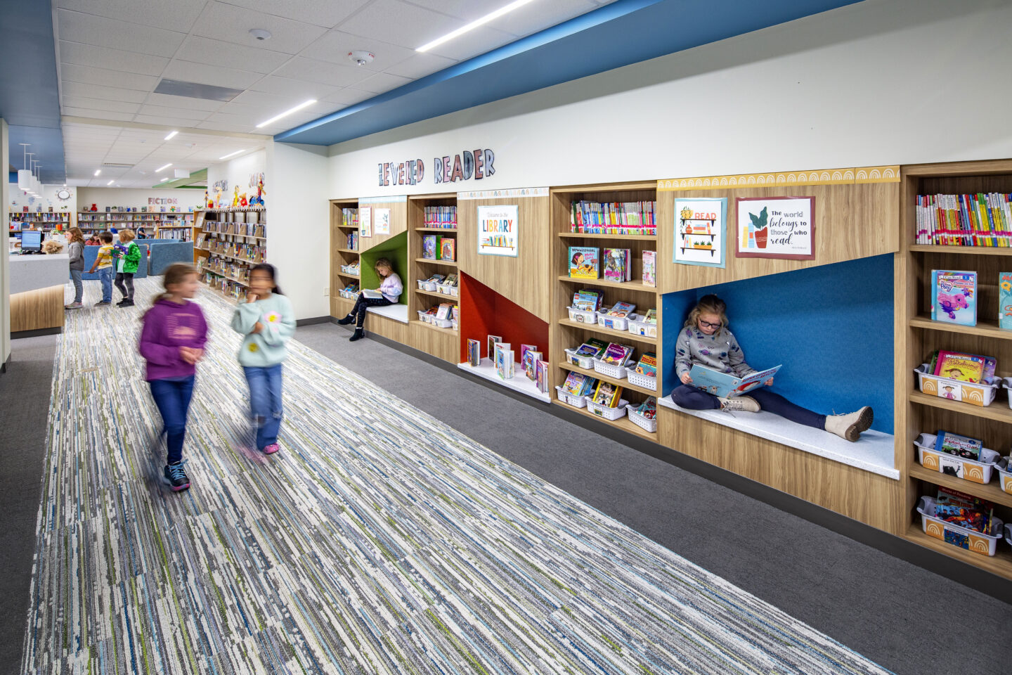 Library entrance at Wrightstown elementary school with students reading in the nooks