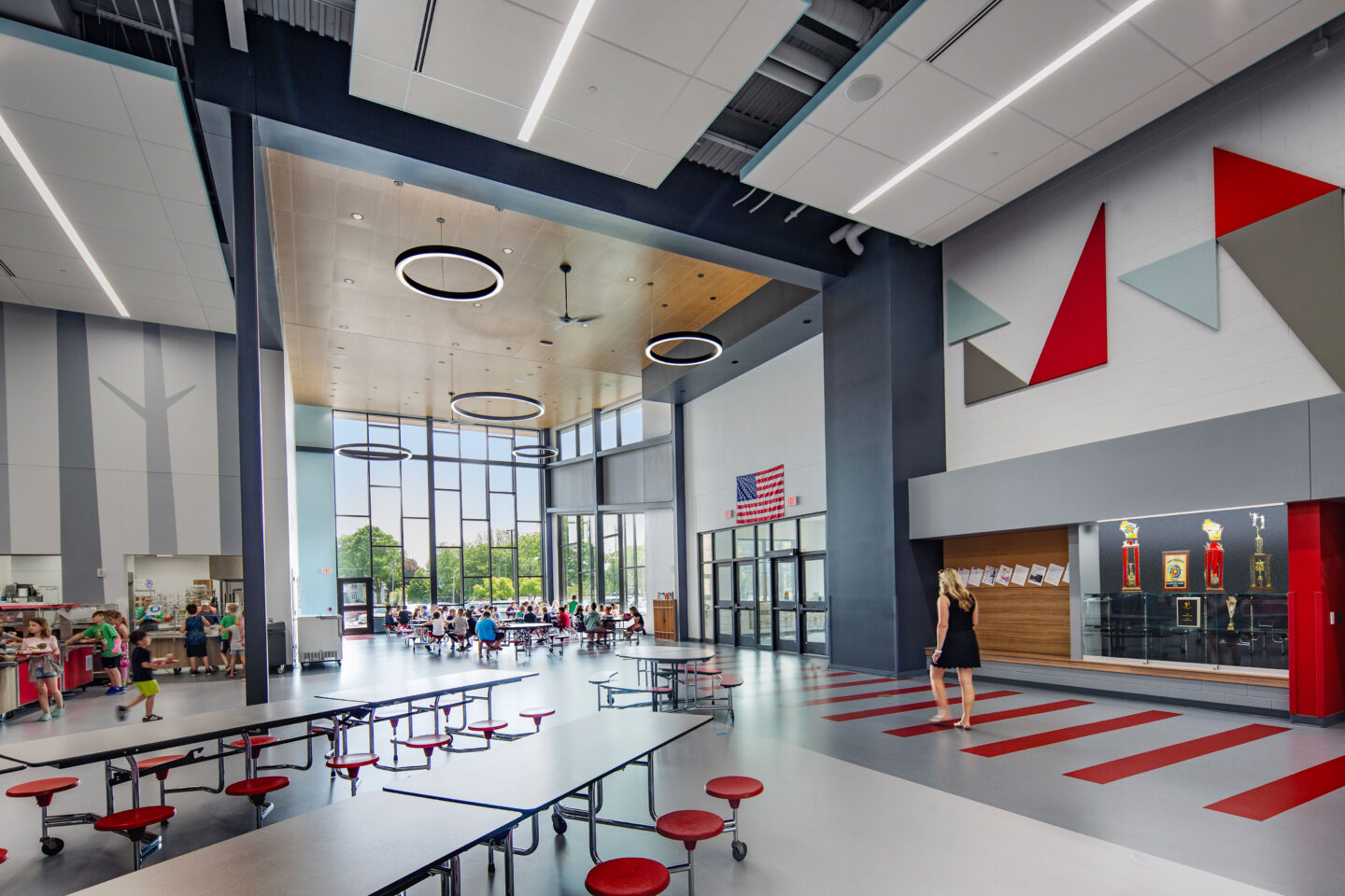 Cafeteria and front entrance doors with circular ceiling lights at Columbus Elementary School