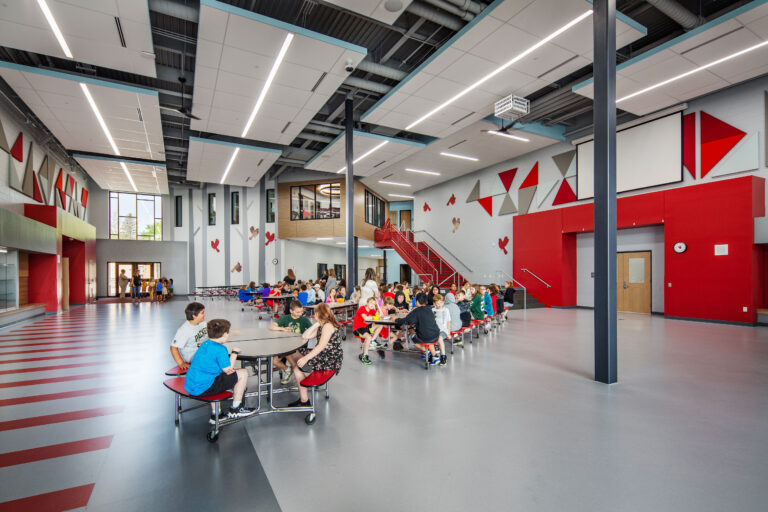 Cafeteria with stairs to second floor visible at Columbus Elementary School