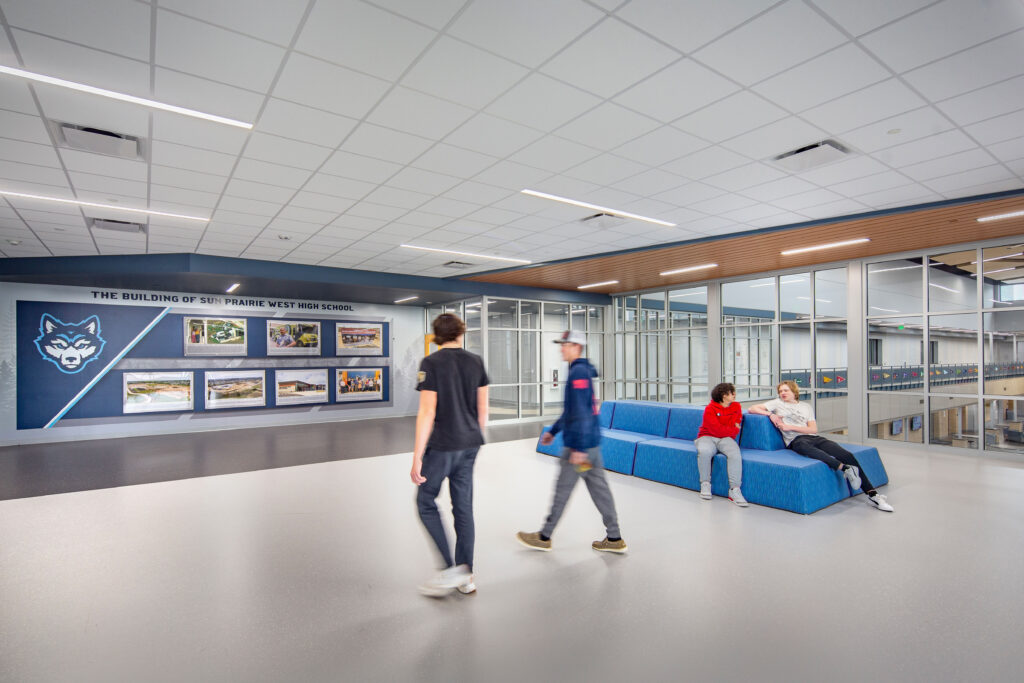 Open area with flexible furniture and history timeline of the school on the back wall