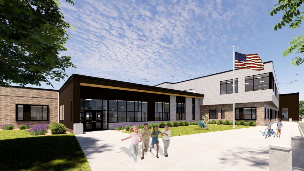 Exterior side of Menominee Elementary School with a flag pole and children playing outside