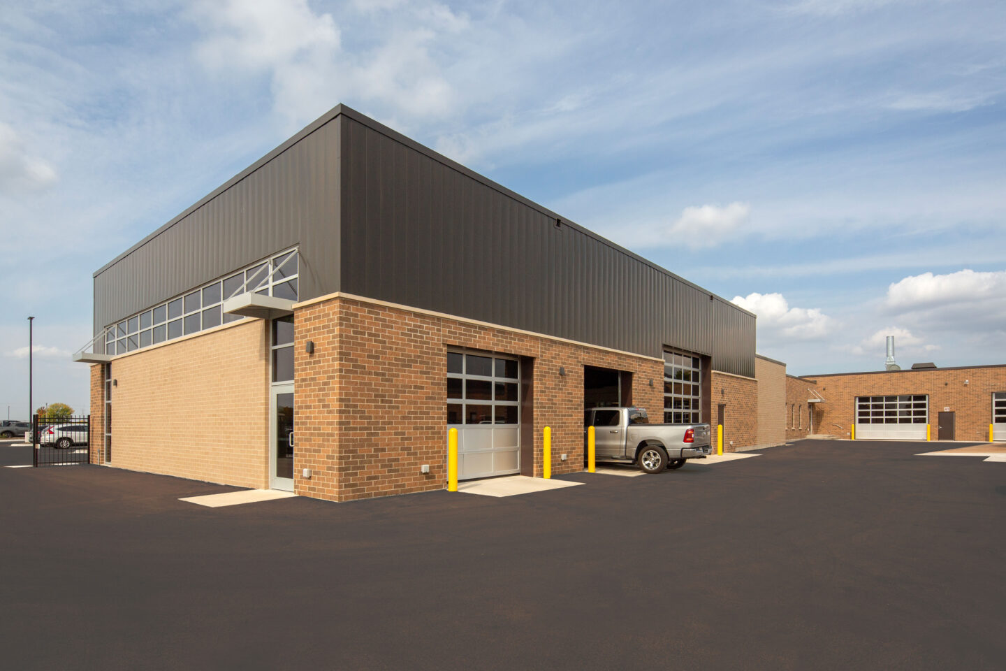 Seymour High School technical education automobile addition with one garage door open and truck entering