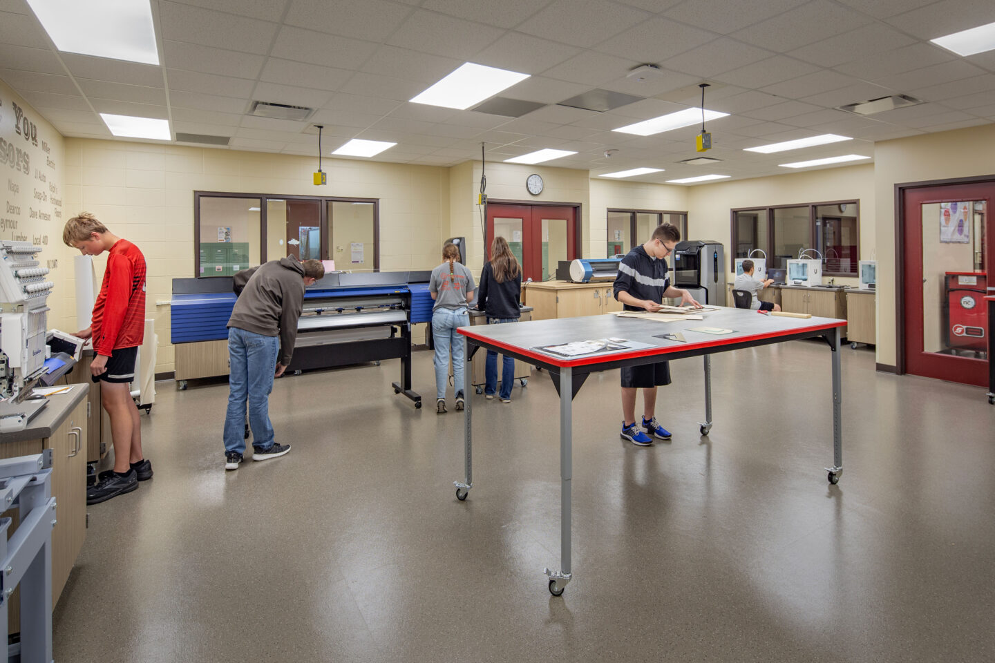 Seymour High School fabrication lab with students working on the machines