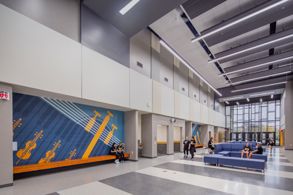 Events lobby with branding walls and students sitting and walking
