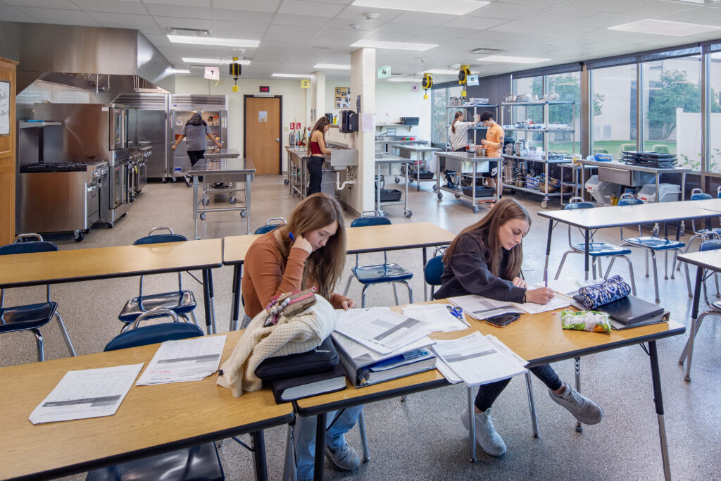 West De Pere high school foods and consumer education classroom and lab with students cooking