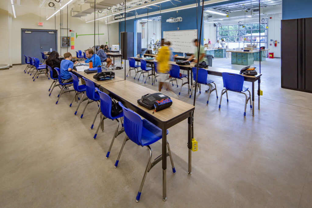 Wrightstown middle school technical education room with workshop area separated by garage doors