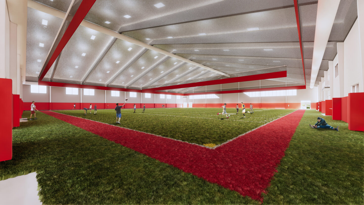 Rendering of the indoor practice facility with athletes running around and playing sports