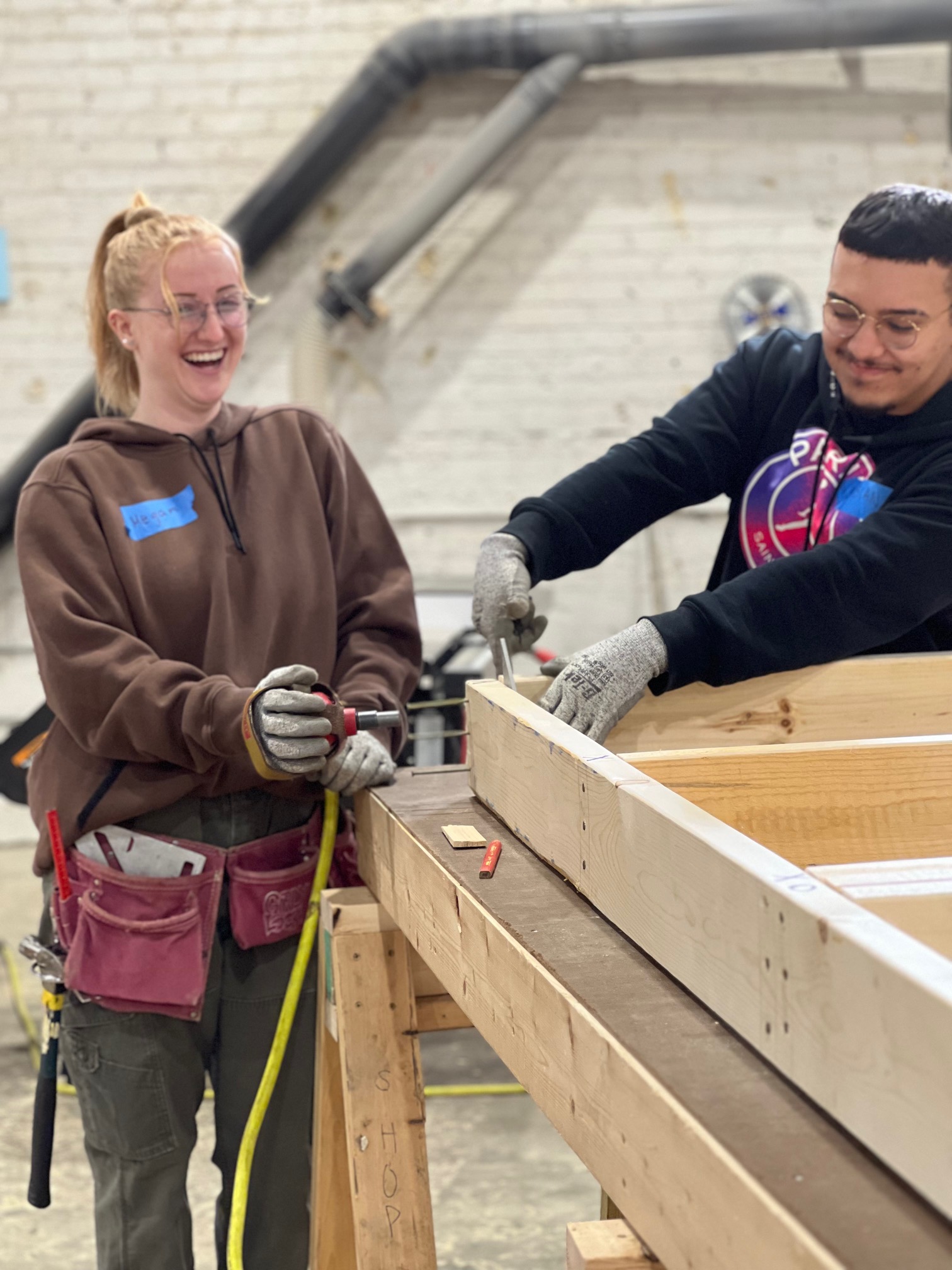 Bray employees drilling into wood at volunteer day